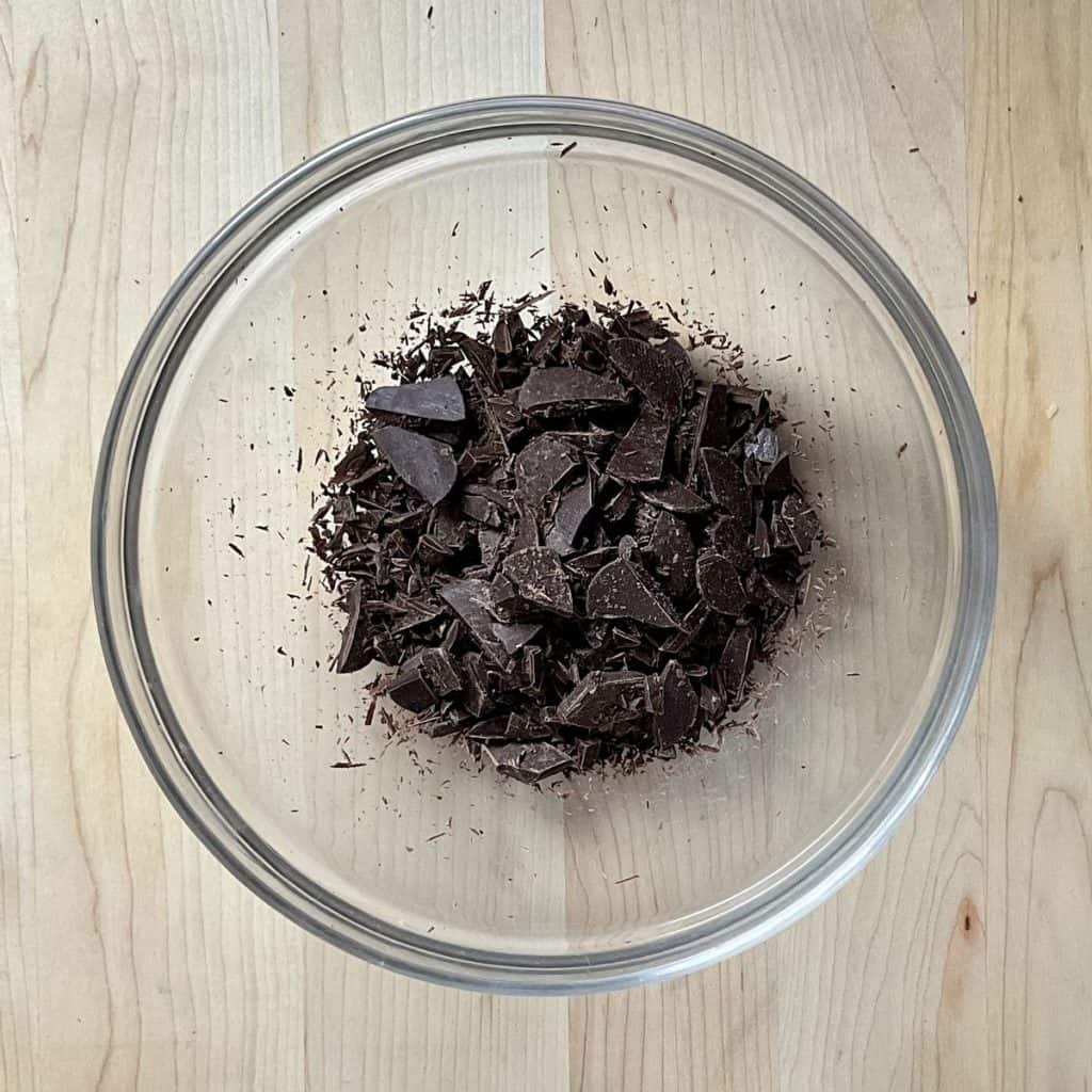 Chopped dark chocolate in a bowl.