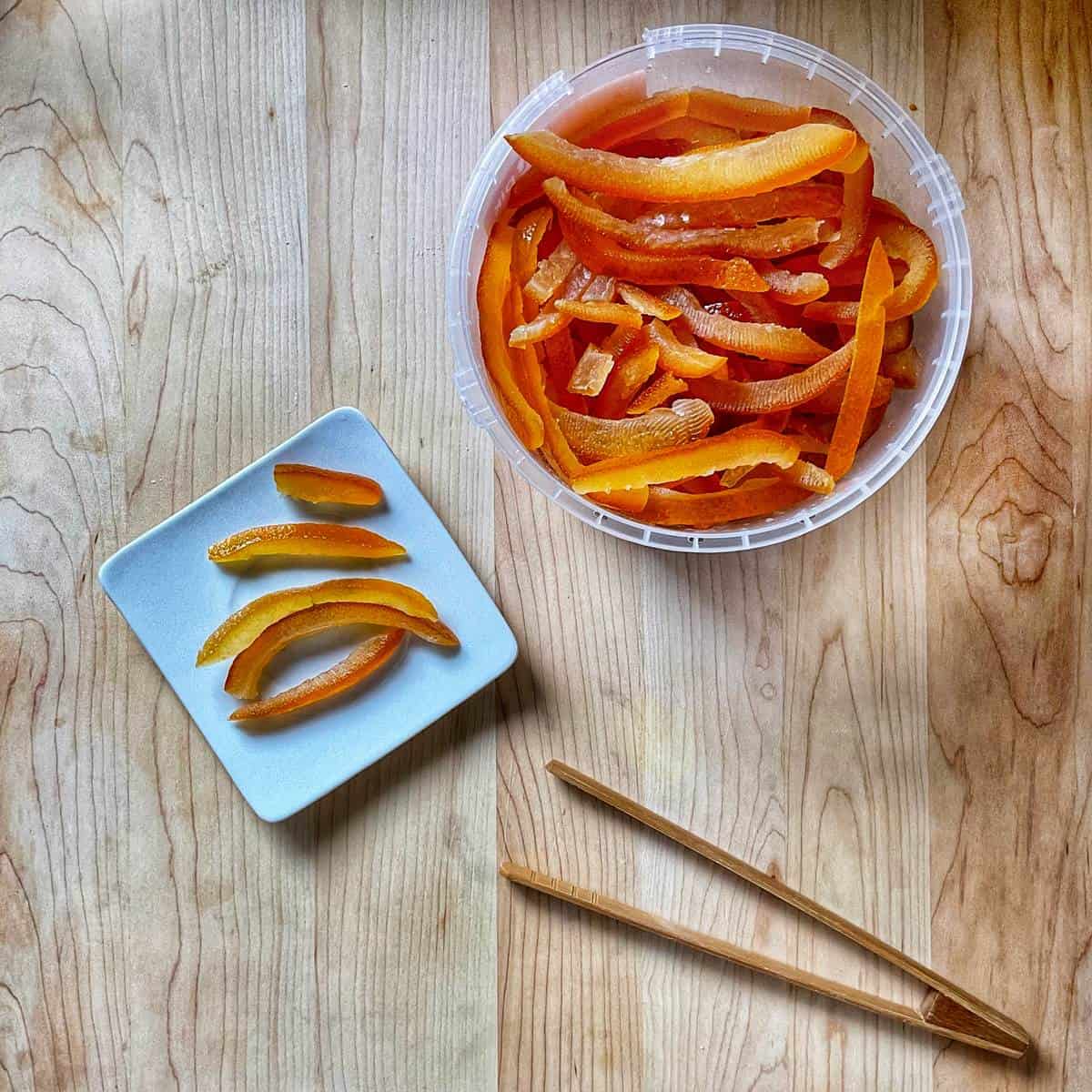 Candied orange peel on a wooden surface.