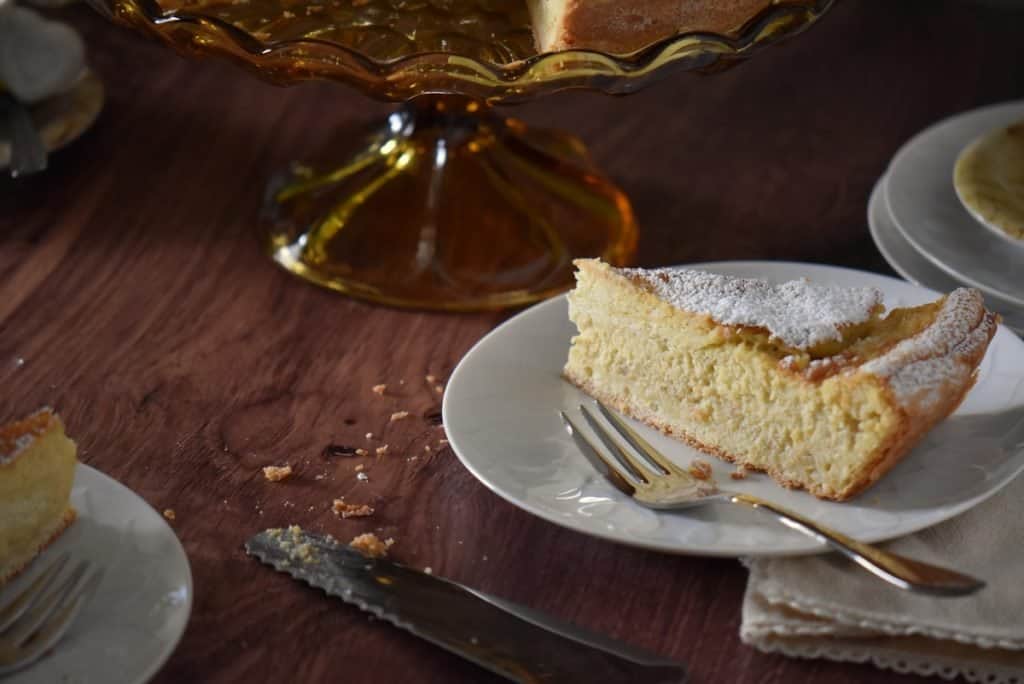 A slice of pastiera on a white dessert plate.