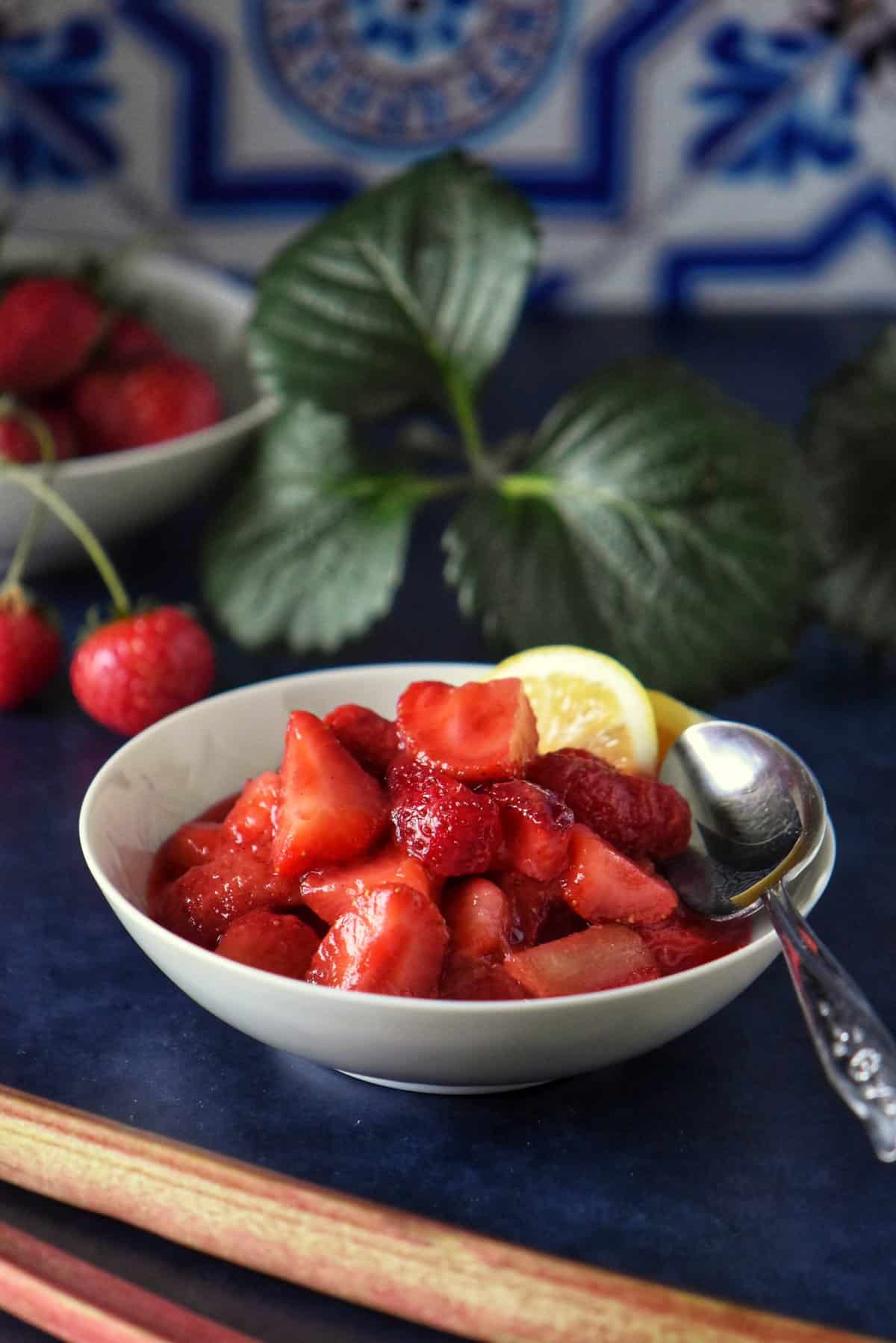 Strawberry rhubarb compote in a white dish.