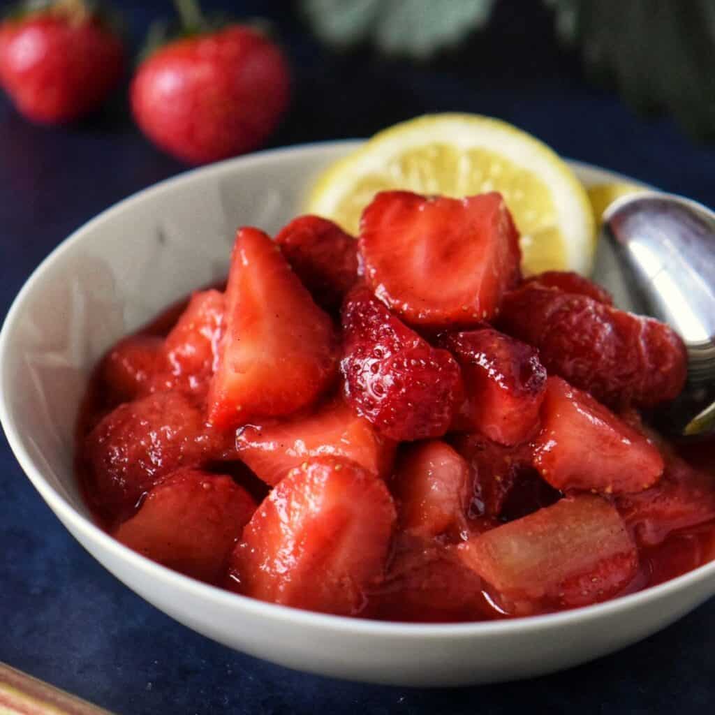 Strawberry rhubarb compote in a white dish.