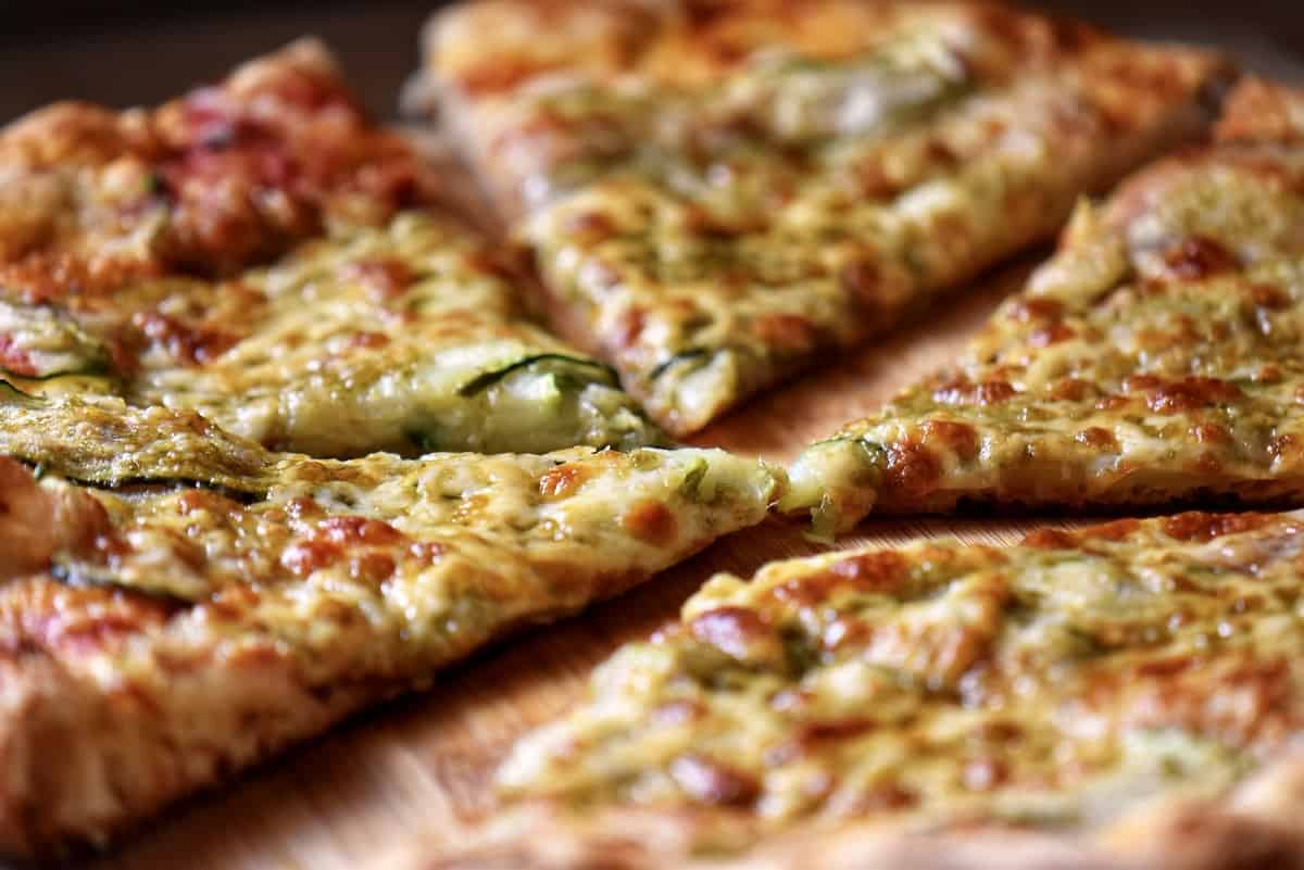 A close up photo of a few slices of zucchini pizza.