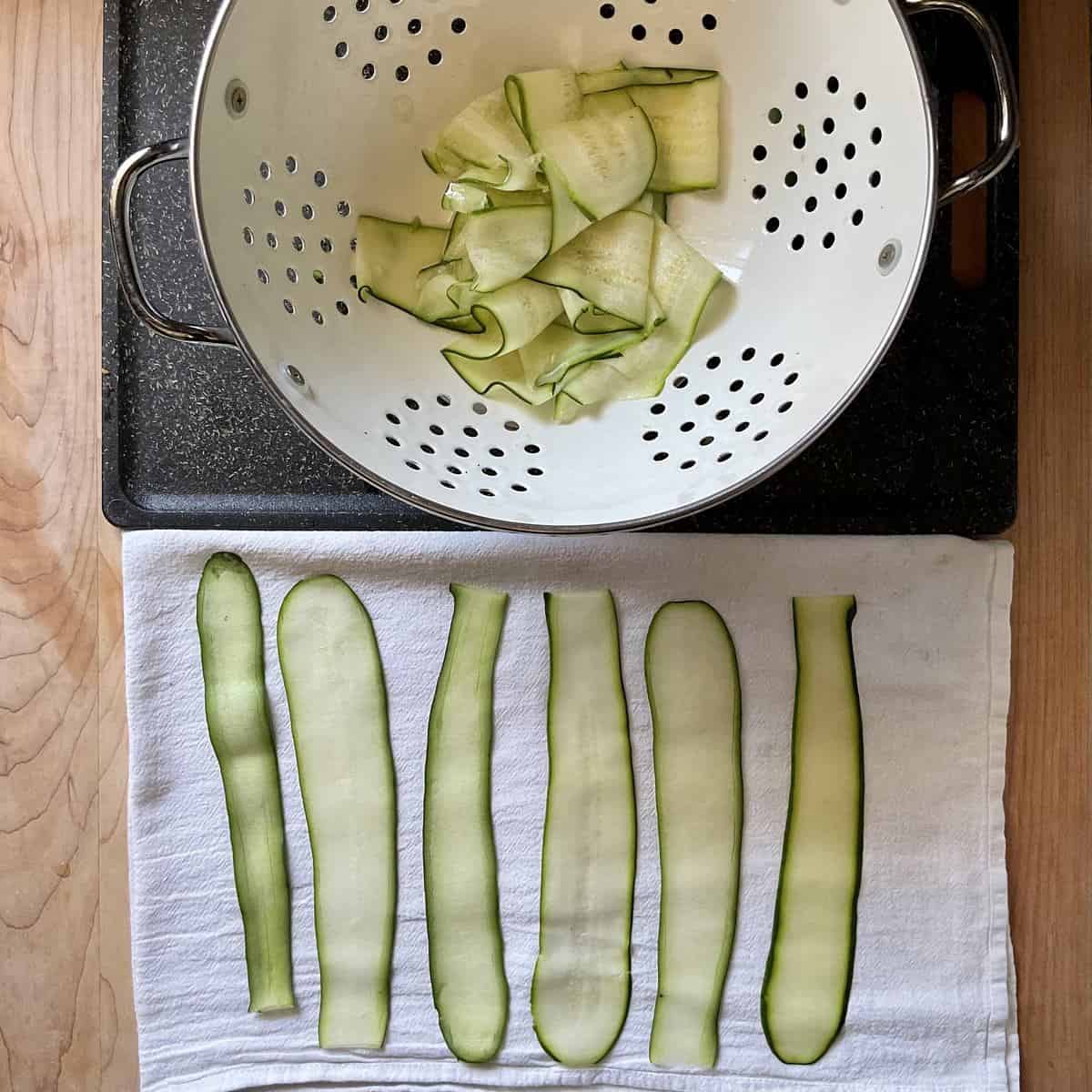 Zucchini ribbons on a tea towel.