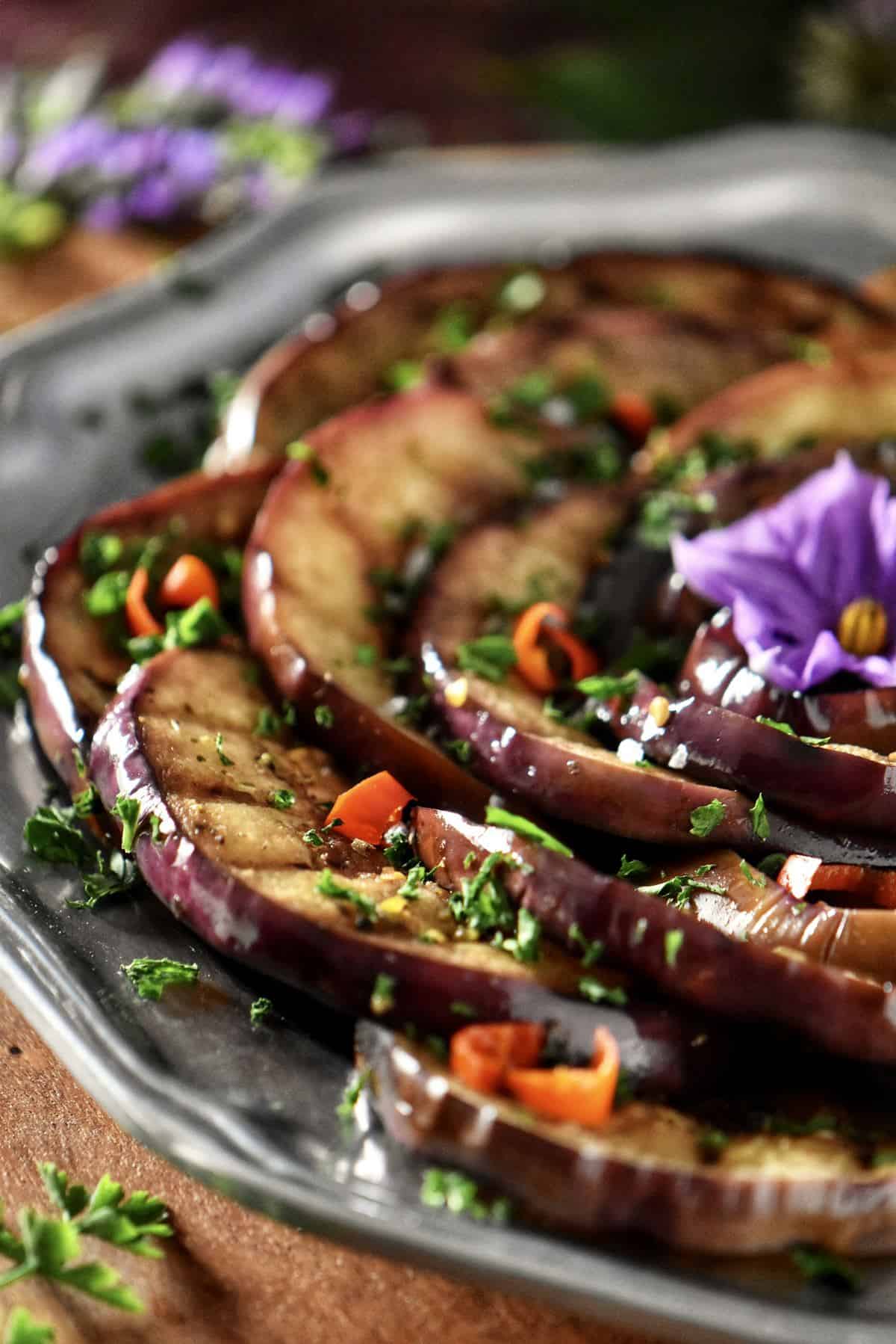 Grilled eggplants garnished with chopped parsley.