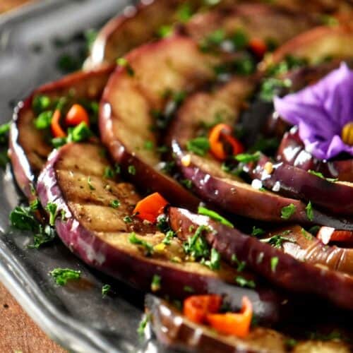 Grilled eggplants garnished with chopped parsley.