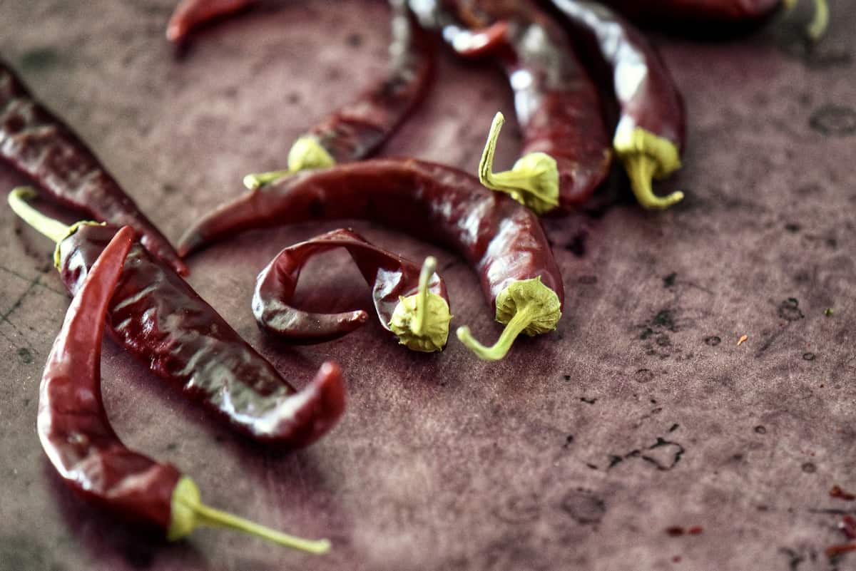 Dry chili peppers on a sheet pan.