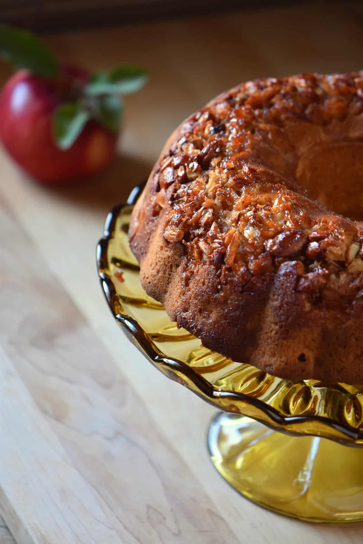 Apple bundt cake on a cake stand.