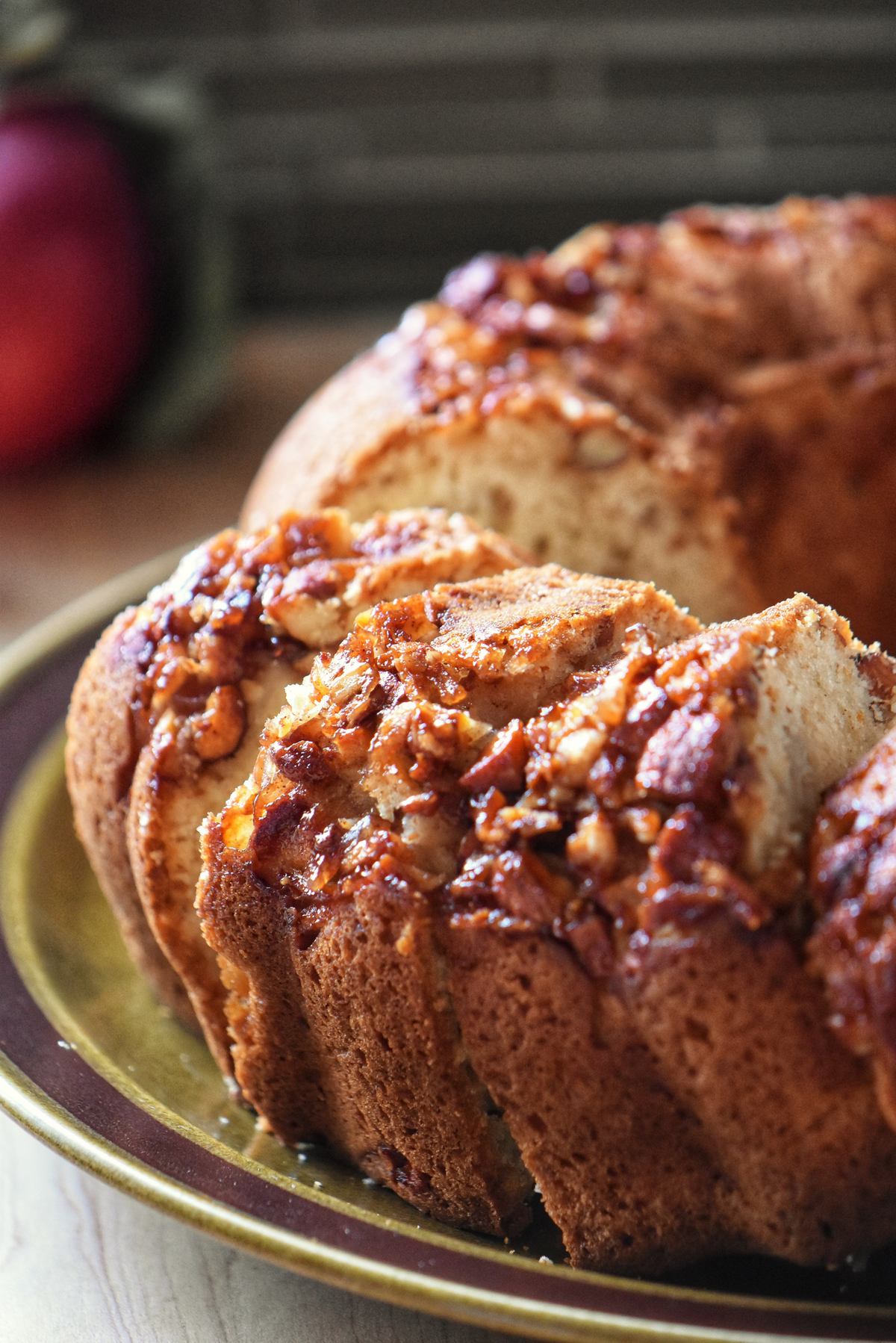 Sliced apple bundt cake on a cake platter.