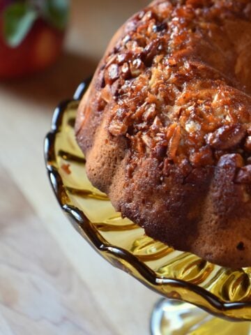 Apple bundt cake on a cake stand.