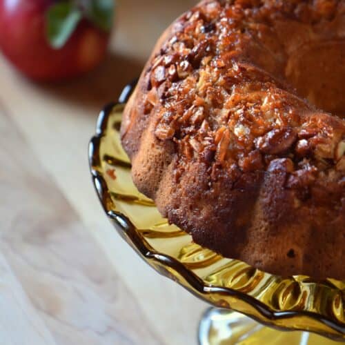 Apple bundt cake on a cake stand.