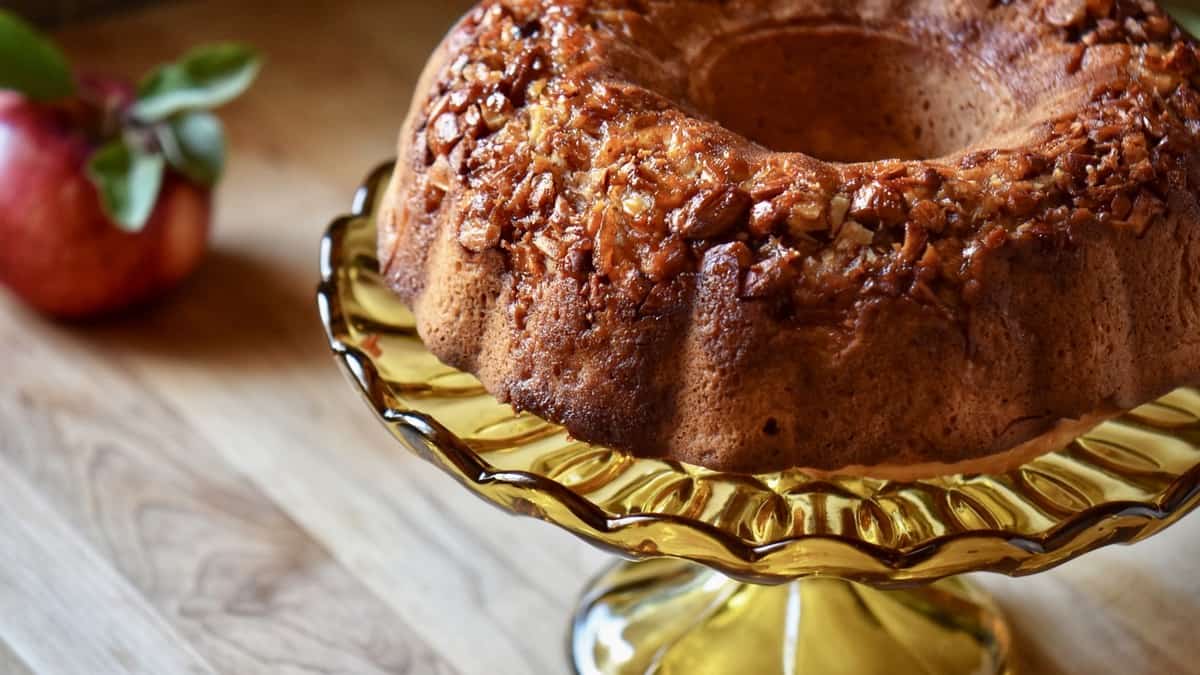 Apple bundt cake on a cake stand.