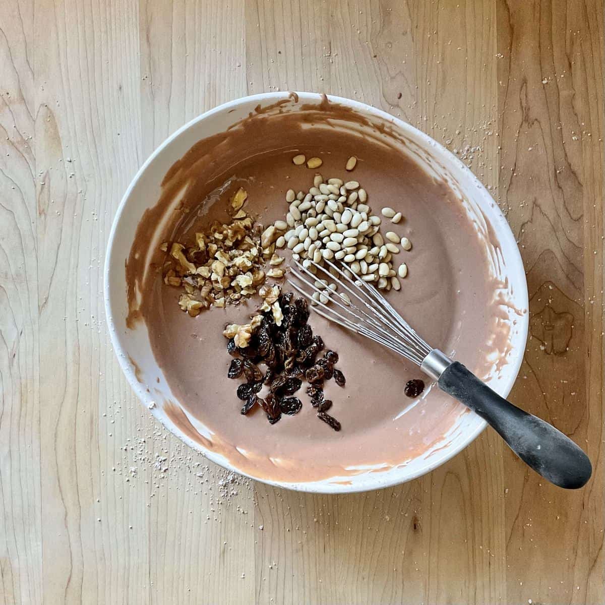 Dried raisins, pine nuts and walnuts add to the cake batter.