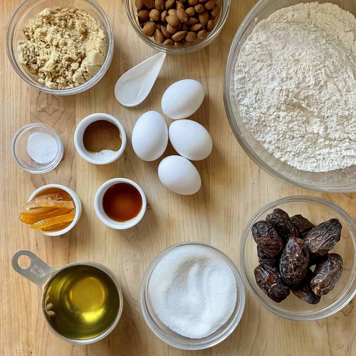 Ingredients to make date biscotti on a wooden board.
