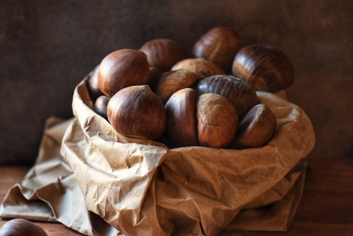 A pile of chestnuts in a paper bag,