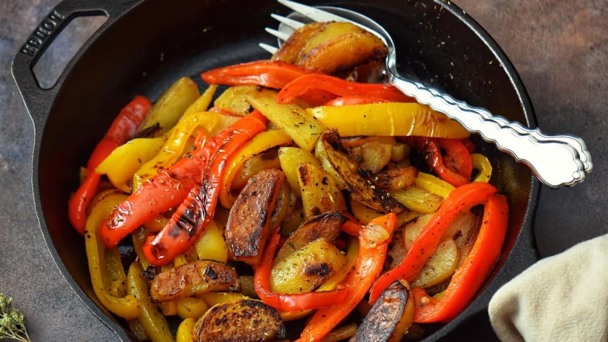 Italian peppers and potatoes in a cast iron pan.