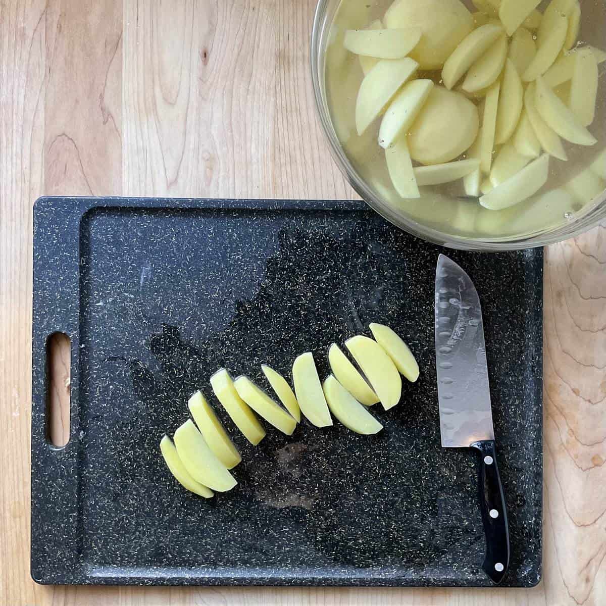 Sliced potatoes on a cutting board.