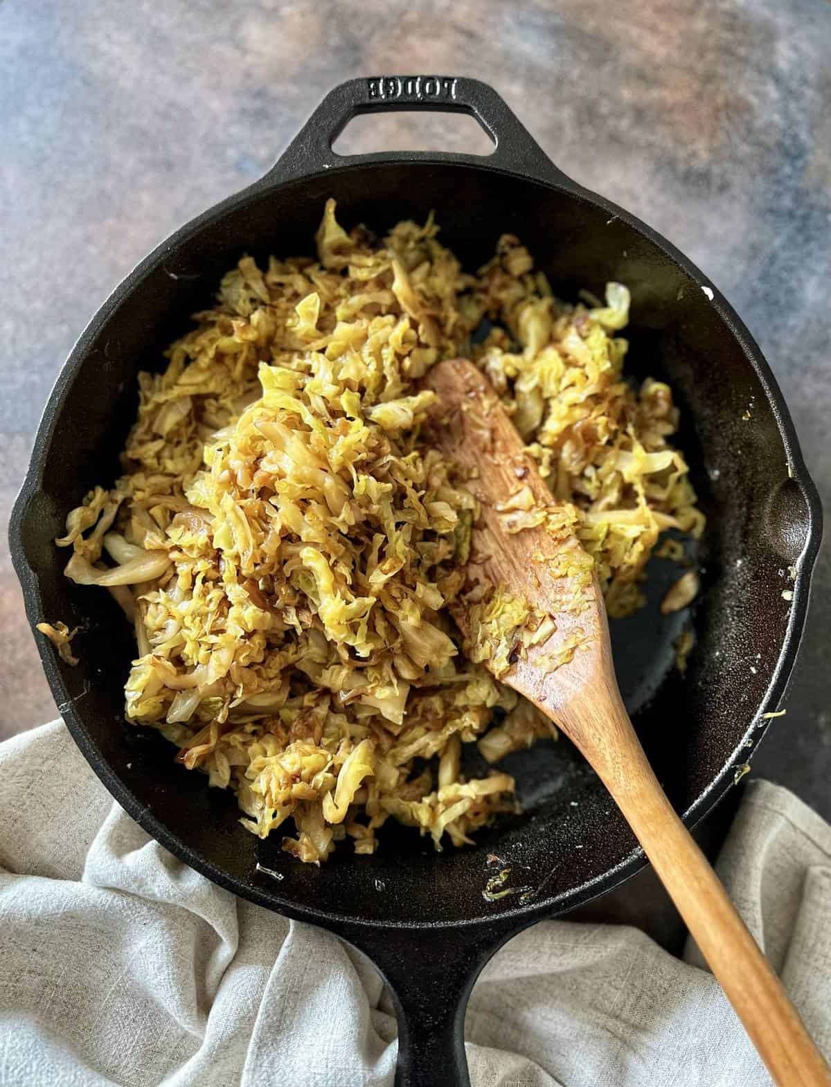 Fried cabbage in a cast iron pan.
