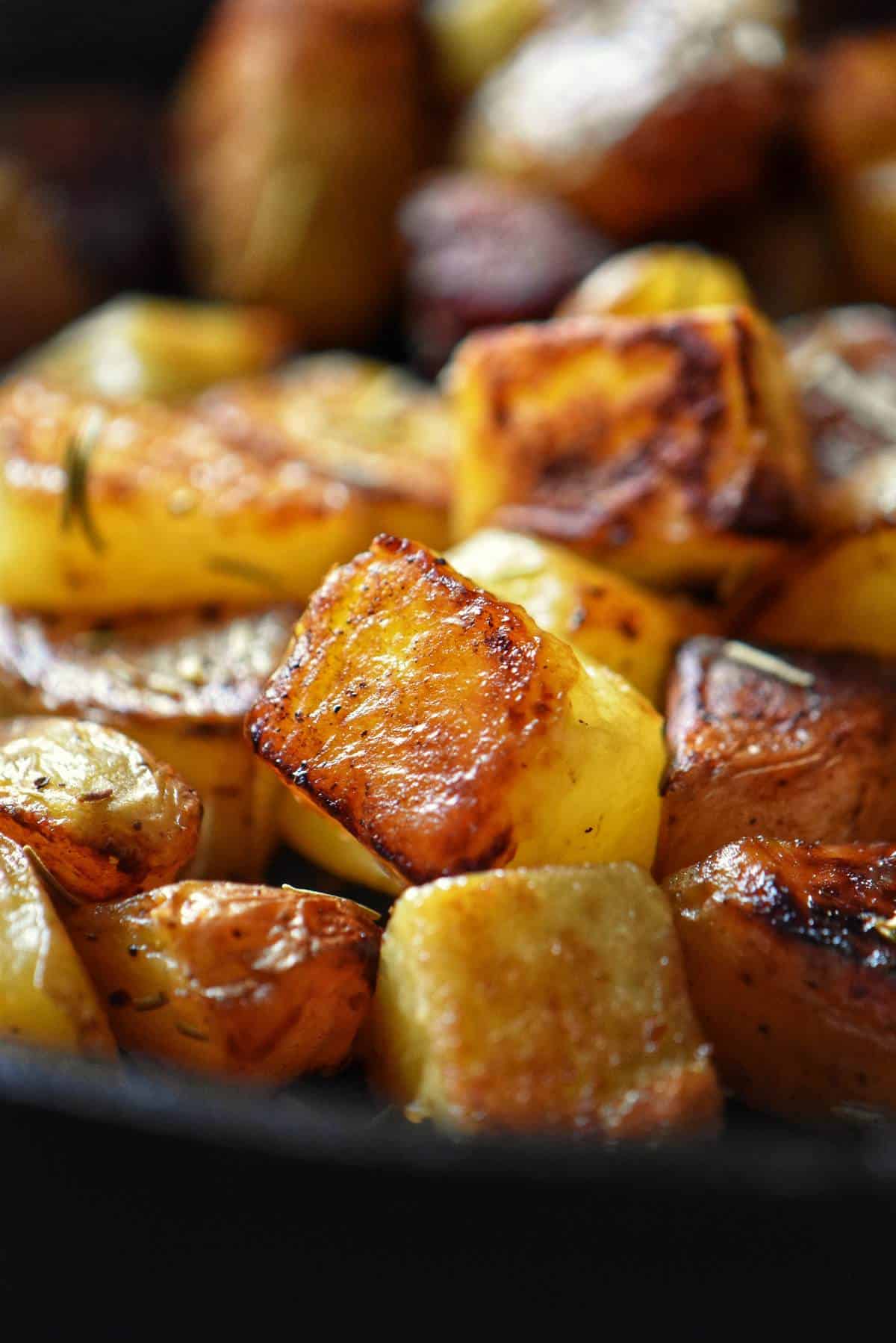 Crispy golden brown potatoes in a cast iron skillet.