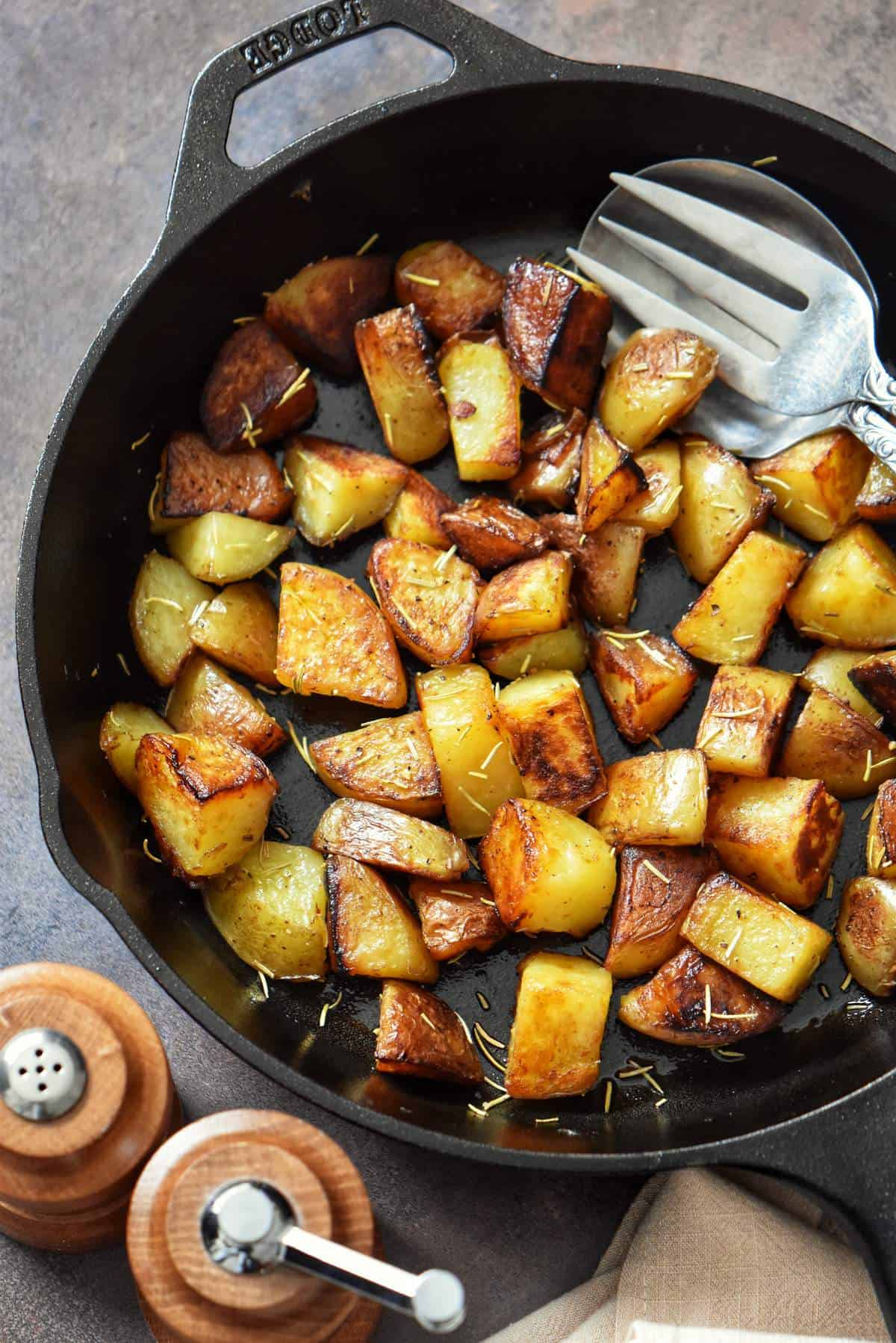 Crispy golden brown potatoes in a cast iron skillet.