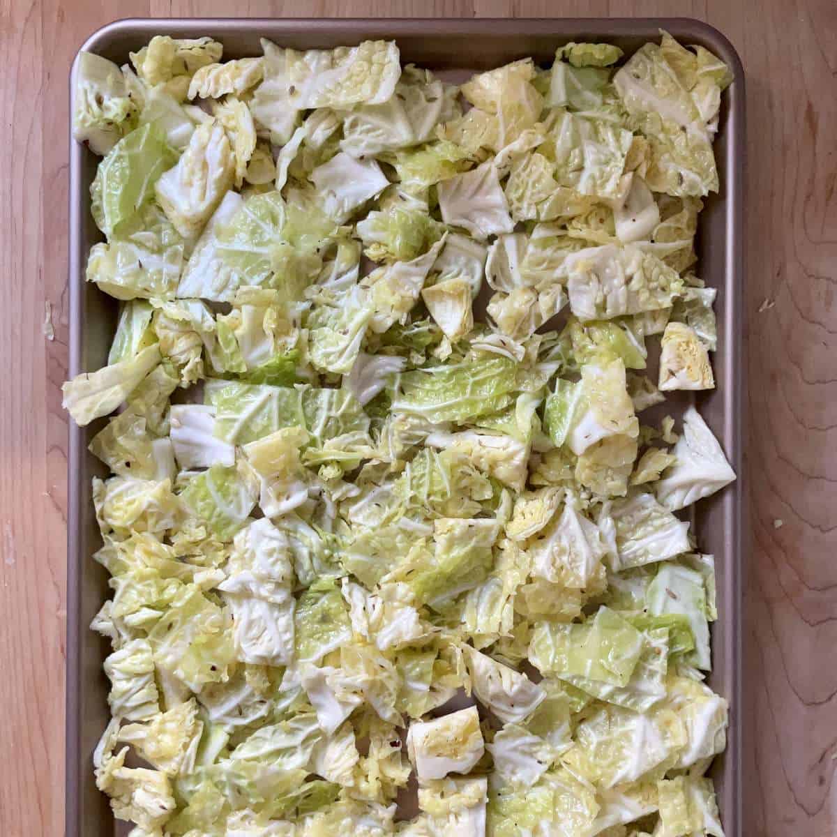 Chopped cabbage on a baking sheet.