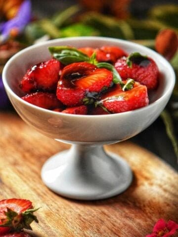 Balsamic strawberries in a white serving dish.