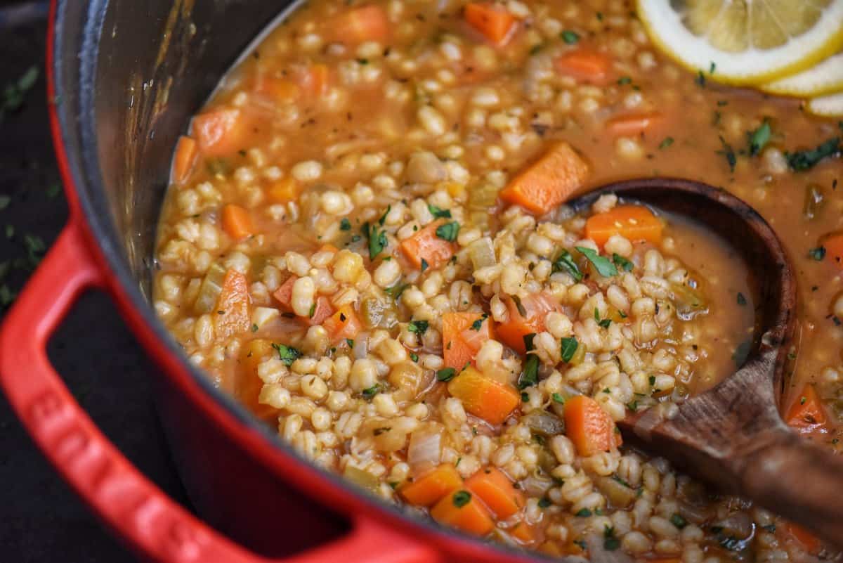 Homemade barley soup in a Dutch oven.