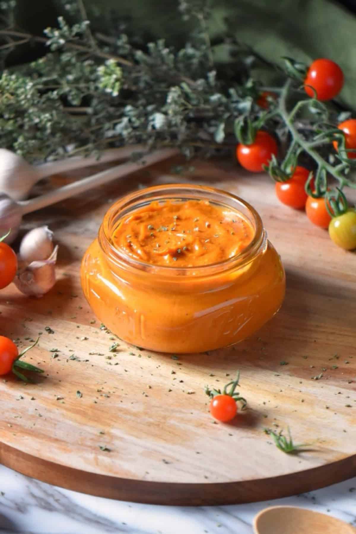 Roasted Cherry Tomato Sauce on a wooden round board.