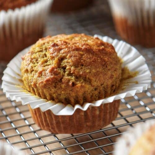 Freshly baked healthy orange muffins with dates and whole wheat flour.