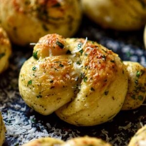 Garlic knots garnished with grated cheese ready to be served.