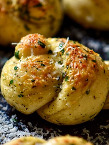 Garlic knots garnished with grated cheese ready to be served.