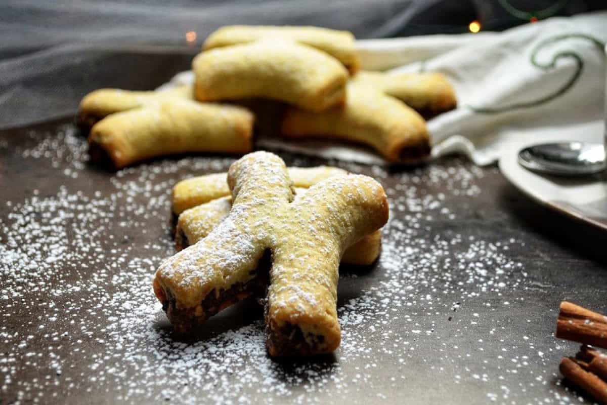 A few Italian fig cookies shaped like an X, garnished with icing sugar. 