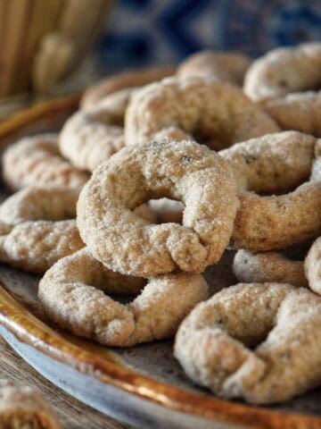 Freshly baked ciambelline al vino on parchment paper.