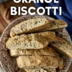 Orange biscotti stacked in a bowl, ready to enjoy with coffee.