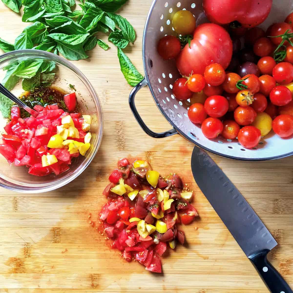 Heirloom cherry tomatoes are chopped into small pieces.