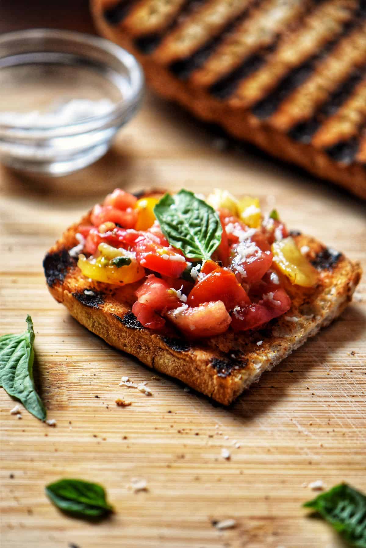 Charred Italian Crusty bread topped with a tomato basil mixture makes the best bruschetta.