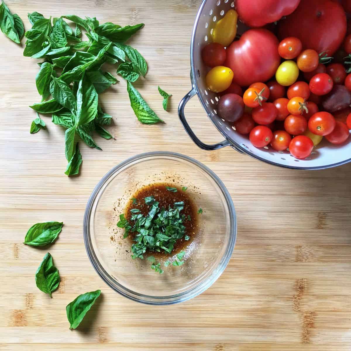 Torn up pieces of basil added to the vinaigrette for the tomato and basil bruschetta.