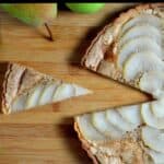 A slice of pear tart on a cutting board.