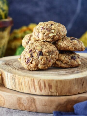 Apple oatmeal cookies stacked on a wooden platter
