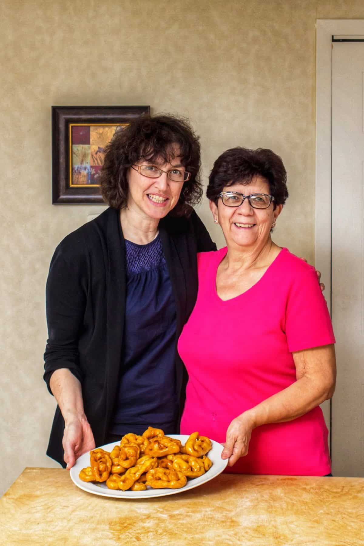A picture of Maria (from She Loves Biscotti) with her friend Maria and a platter of freshly made Caragnoli.