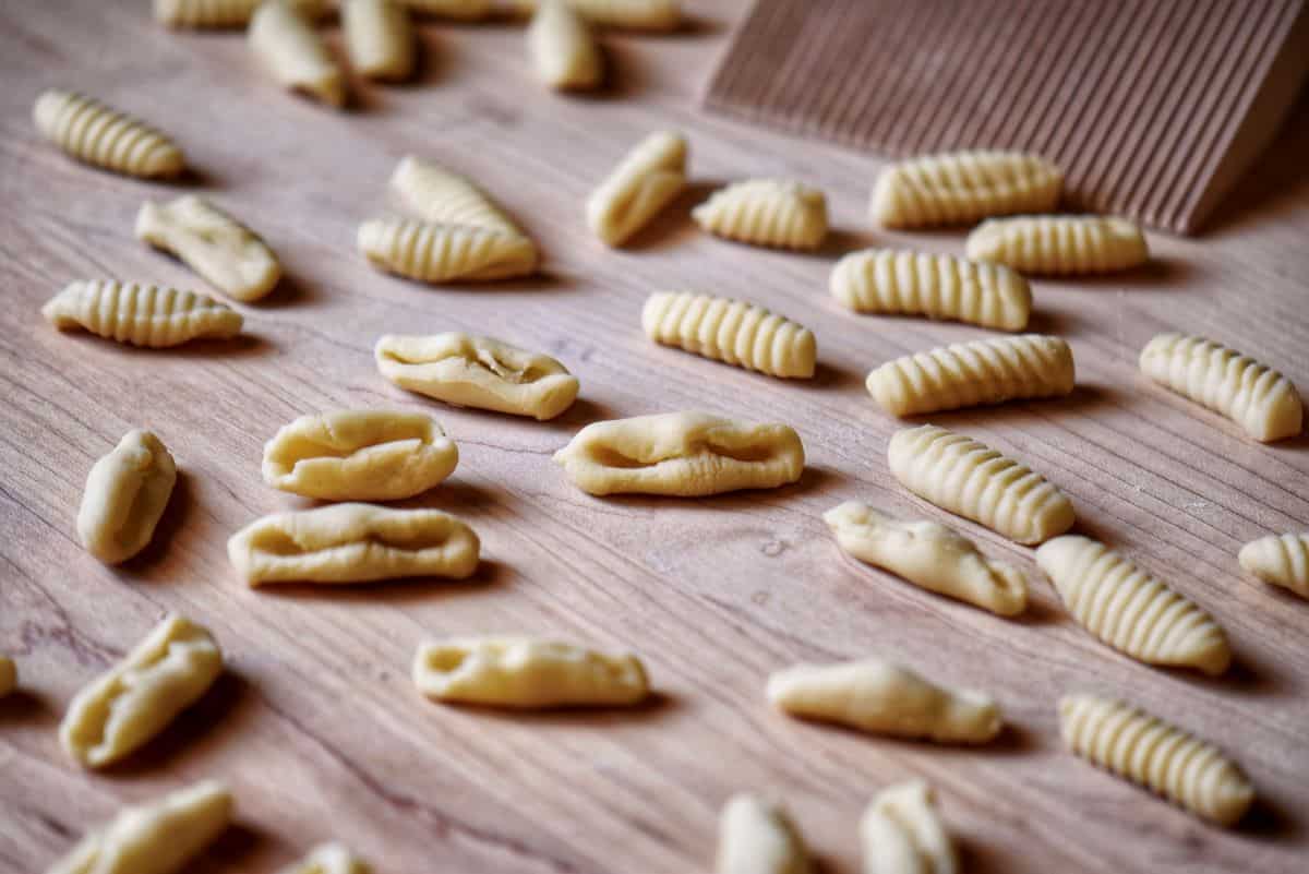 Cavatelli next to a gnocchi board.