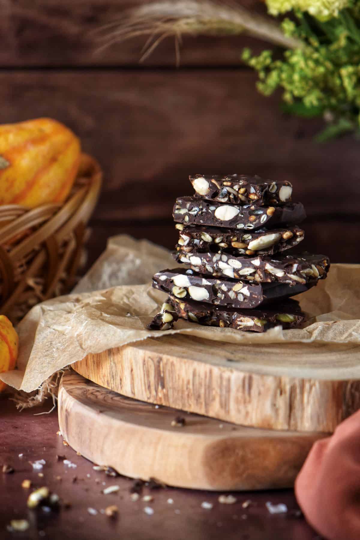 Dark chocolate bark with pumpkin seeds on parchment paper.