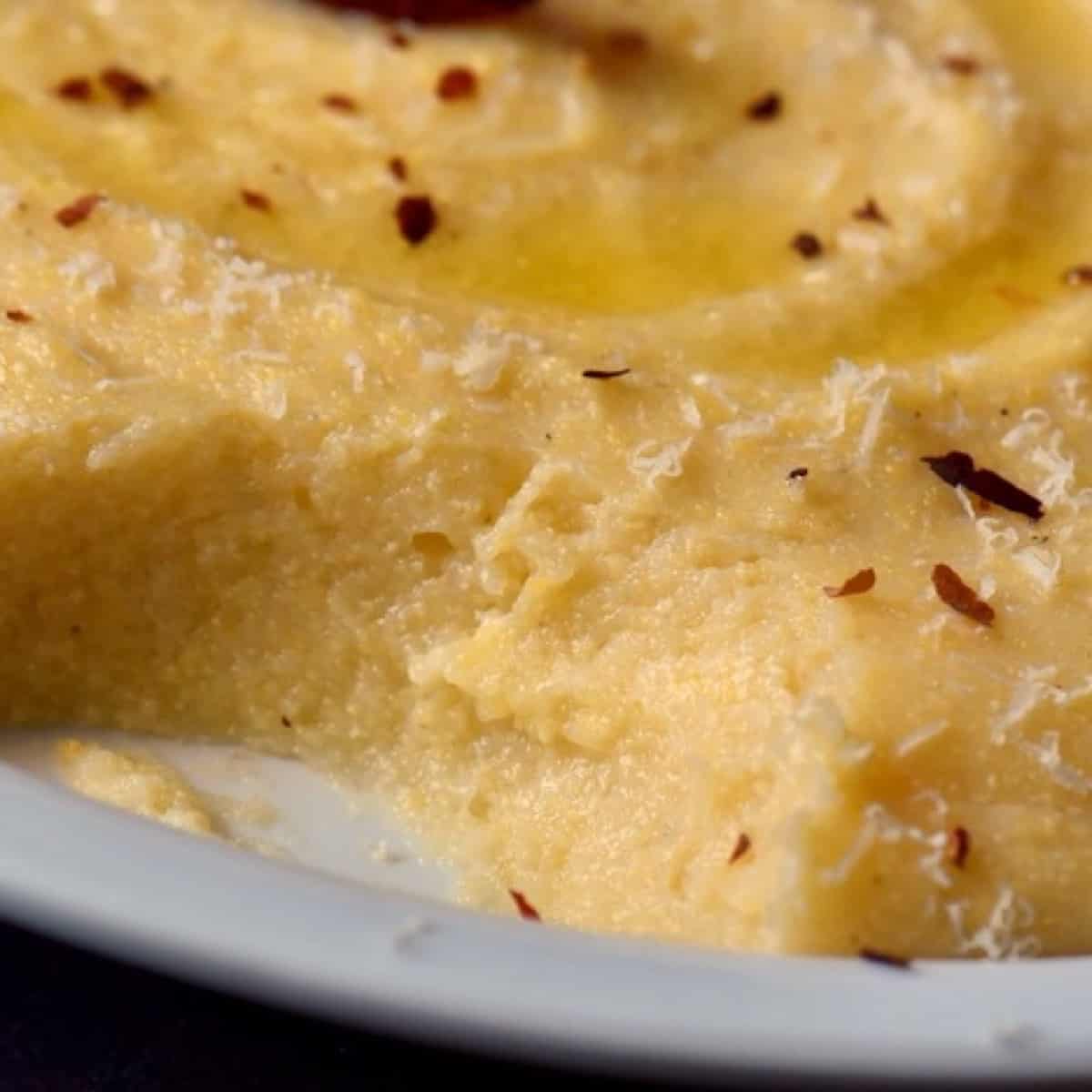 A close up shot of the creamy texture of freshly made Italian polenta.