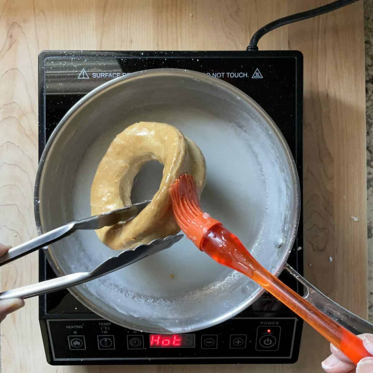 A tarallo in the process of being glazed.