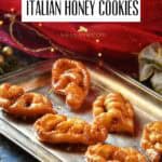 A few Caragnoli, aka Italian Christmas fritters drenched in honey on a silver tray.