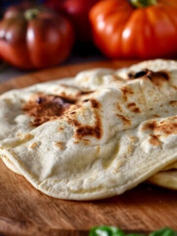 A few piadina on a wooden board.