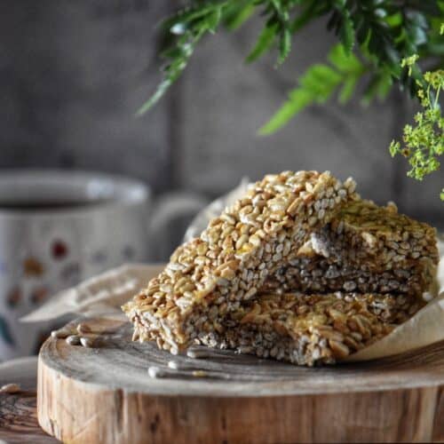 Rectangle pieces of sesame seed candy on a wooden board.