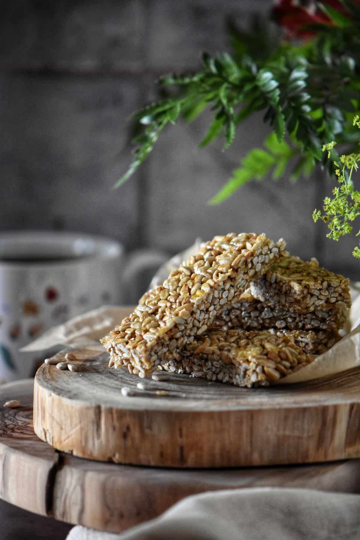 Rectangle pieces of sesame seed candy on a wooden board.