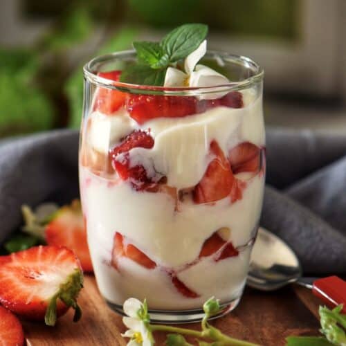 Strawberries and ricotta in a dessert glass.