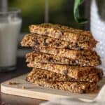 Chocolate chip granola bars on a wooden cutting board.