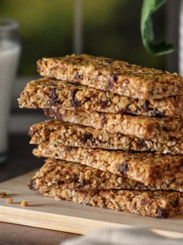 Chocolate chip granola bars on a wooden cutting board.